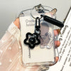 A clear card holder with a keychain featuring a black paw print and a silver star charm.