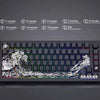A close-up view of a mechanical keyboard featuring translucent Ukiyo-e style keycaps and a decorative landscape design.