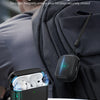 A black magnetic locking lid case for AirPods Pro is shown attached to a gray backpack.