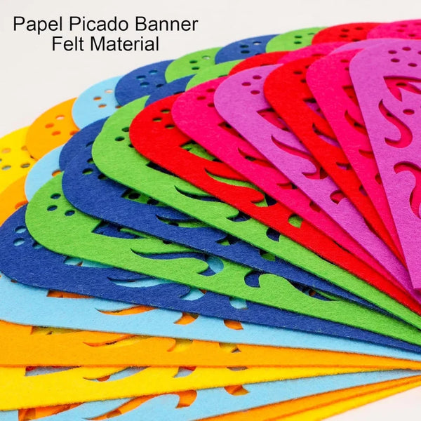 A fan of colorful papel picado banners made of felt material, showing various shades of pink, red, green, blue, and yellow.