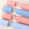 Various colors of gradient double-sided tape pens are arranged on a white surface.