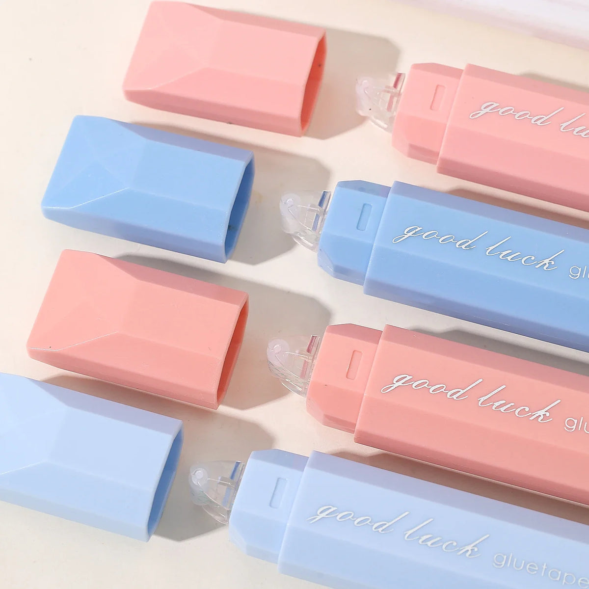 Various colors of gradient double-sided tape pens are arranged on a white surface.