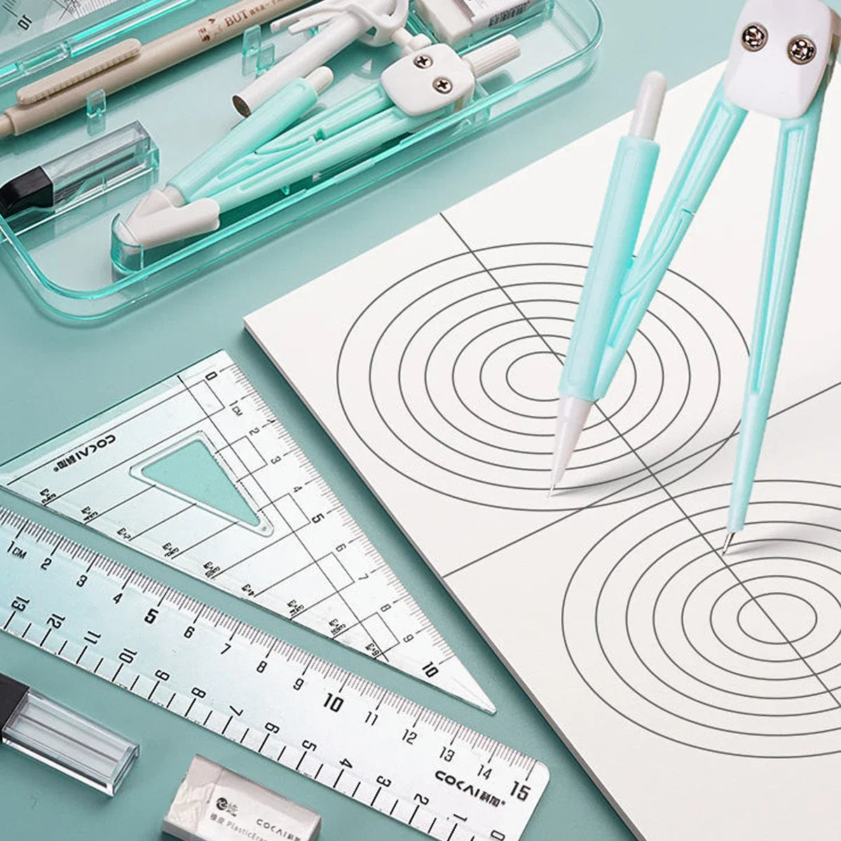 A set of nine geometry drawing tools including pens and a ruler displayed on a white sheet.