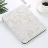 A white marble-patterned silicone skin for an iPad Pro placed on a white surface.