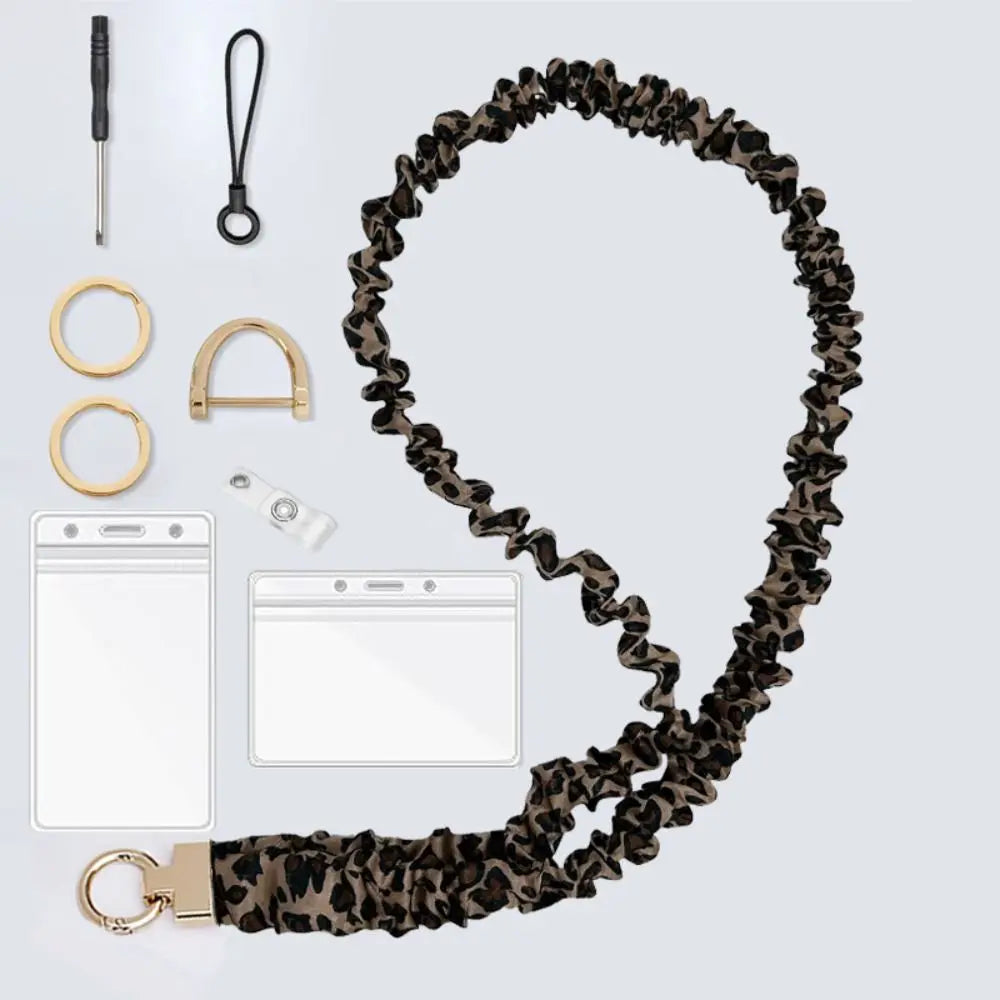 A close-up view of a stylish brown leopard print stretchy breakaway ID badge lanyard with a retractable reel and metal clip.