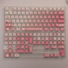 A translucent pink PBT keycap set for mechanical keyboards featuring an alphanumeric layout.