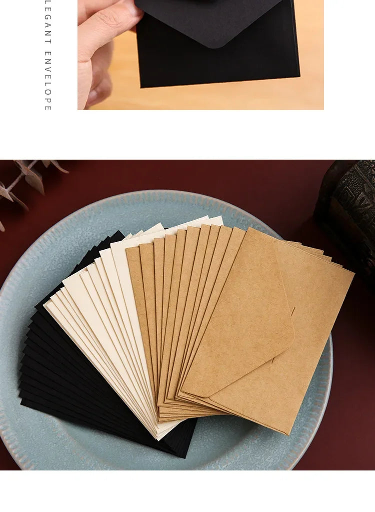 Una pila de sobres vacíos para invitaciones de boda de papel kraft en colores negro y caqui, exhibidos en un plato azul claro