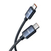 A close-up view of a black braided nylon 120W USB-C to USB-C fast charging cable with metal connectors.