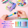 Hands hold a colorful plastic beaded ballpoint pen next to a stack of thank you themed pens.