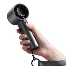 A hand holds a black handheld fan with an LED display, showing the fan in use.