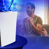 A person is playing a video game while a PS5 cooling fan with an LED light is visible on a table.
