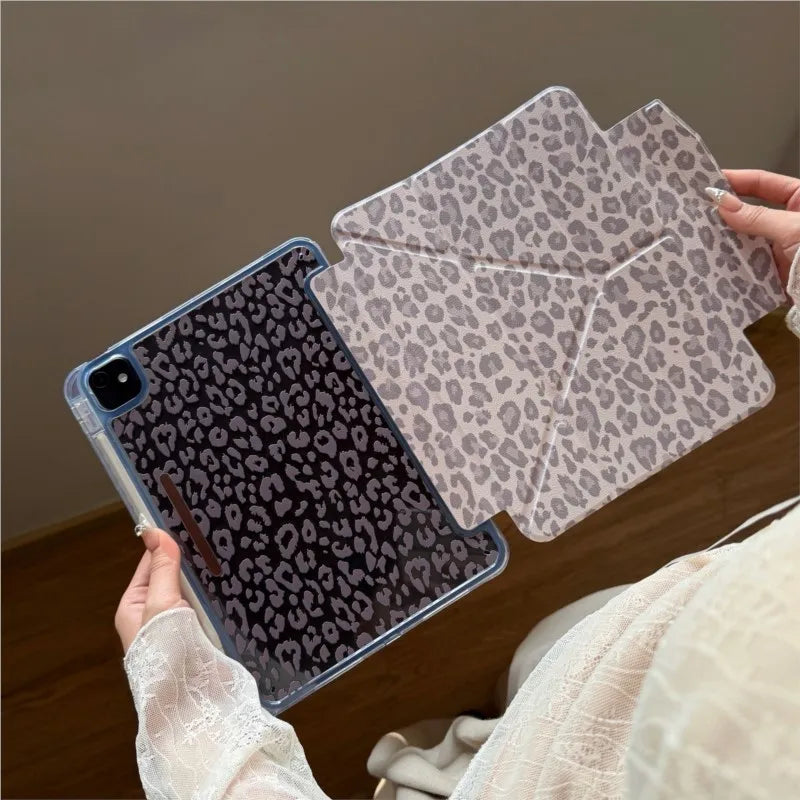 A clear leopard print leather case is shown protecting an iPad, with a matching patterned cover piece nearby.
