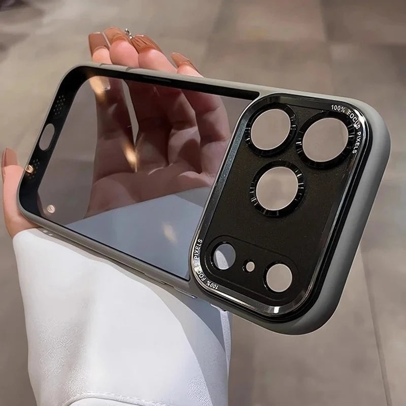 A hand holds a clear shockproof case with camera lens protection for an iPhone, showing the back camera module.