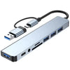 A silver USB hub docking station with a black cable and multiple ports.