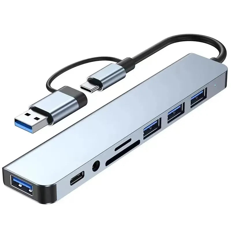 A silver USB hub docking station with a black cable and multiple ports.