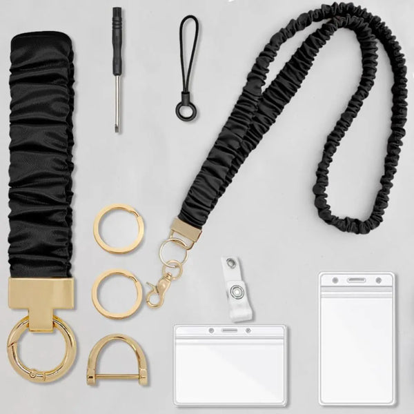 Black stretchy breakaway lanyard with gold hardware and a retractable reel for an ID badge.