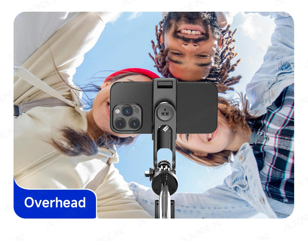 Overhead view of a person using an extendable selfie stick tripod for a group photo.