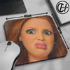 A close-up of a mouse pad featuring a realistic doll face design with measurements marked on the pad.