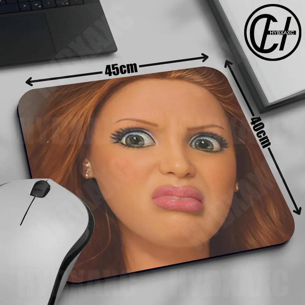 A close-up of a mouse pad featuring a realistic doll face design with measurements marked on the pad.