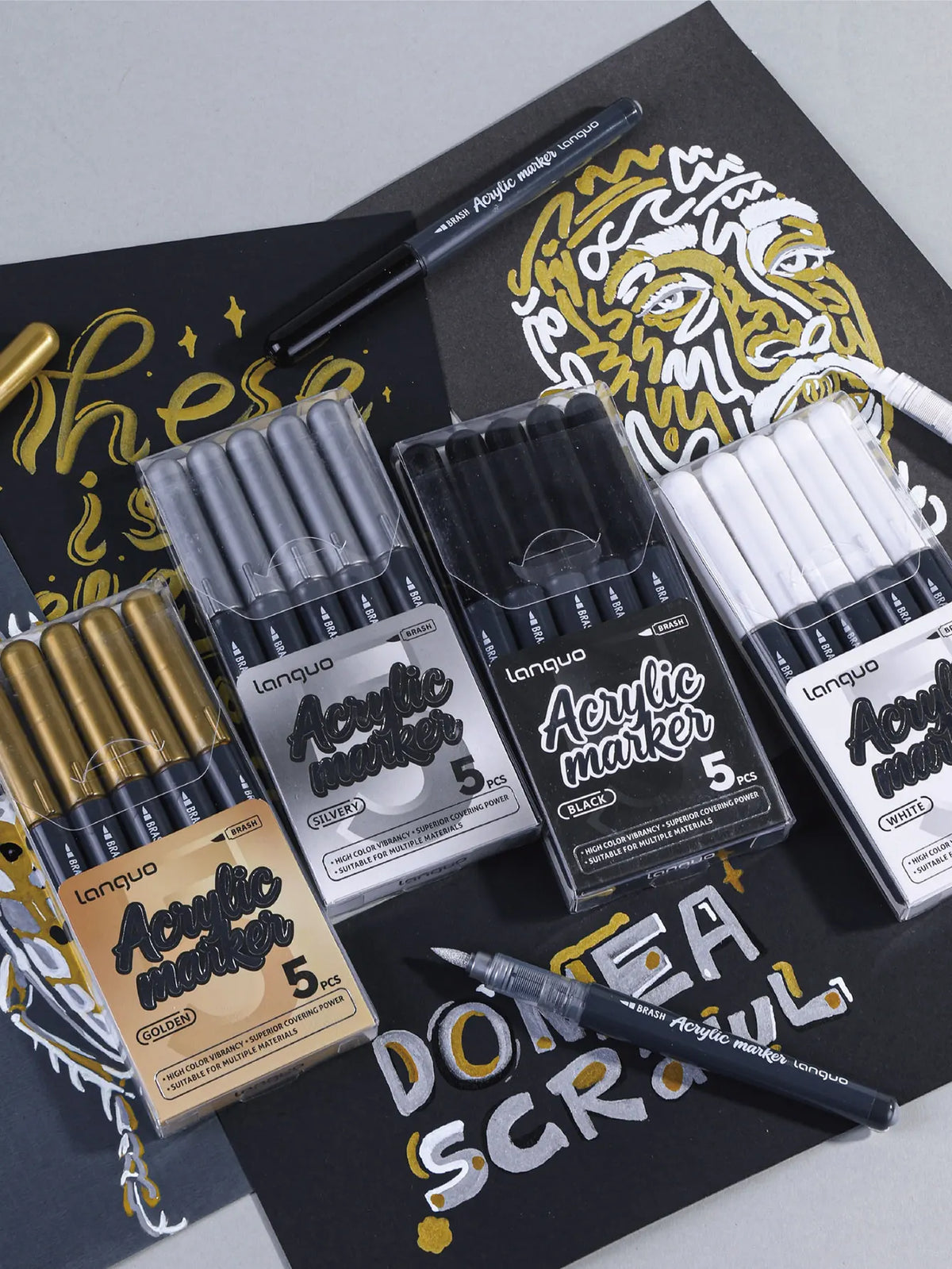 A collection of Languo acrylic marker pens in various colors including silver, black, and white, displayed on a dark backgrou