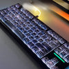 A close-up view of a translucent cherry mechanical keyboard featuring spiderweb-like keycap designs.