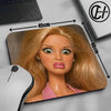 A blonde doll face mouse pad with a non-slip rubber base shown next to a computer mouse.