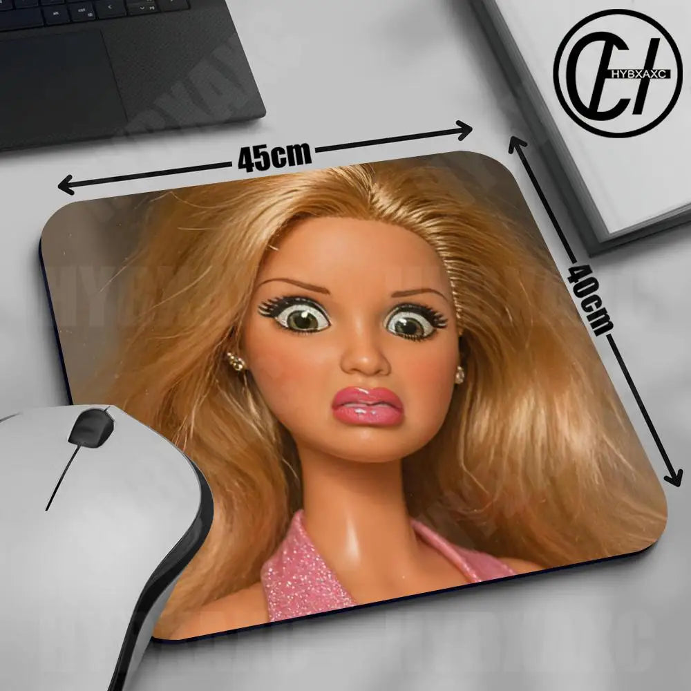 A blonde doll face mouse pad with a non-slip rubber base shown next to a computer mouse.