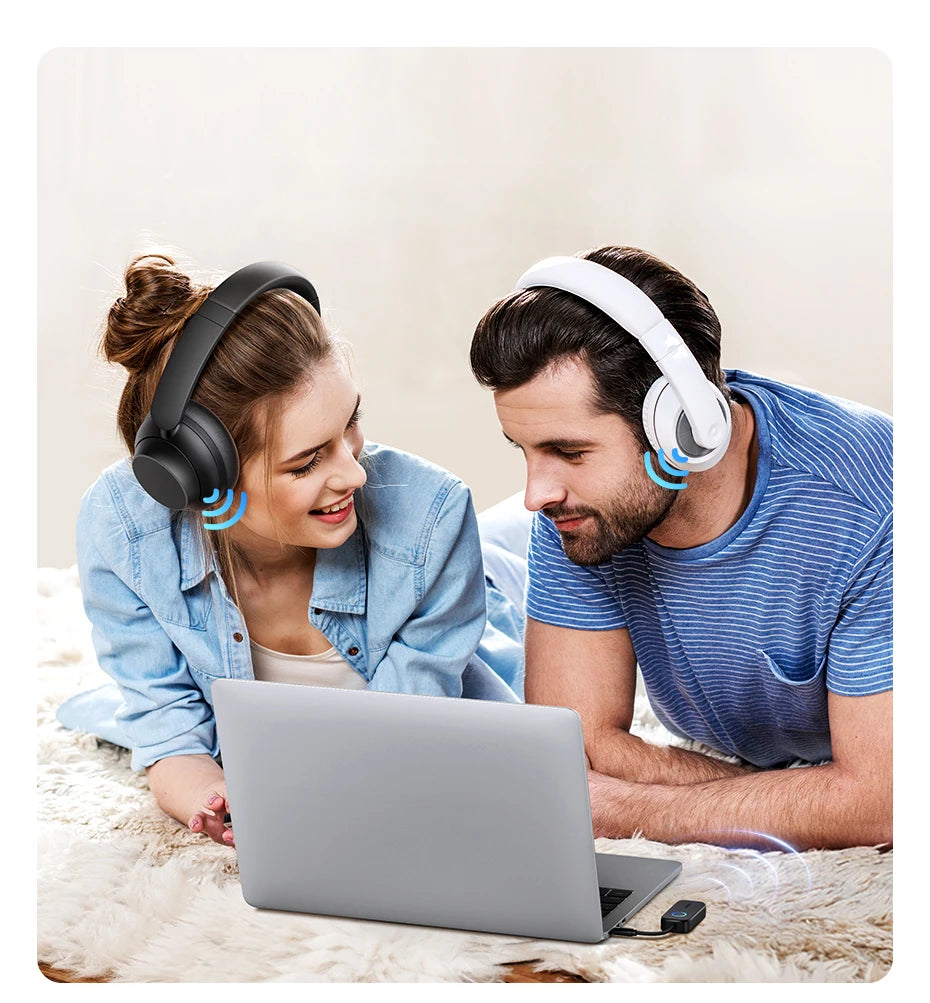 Eine Frau und ein Mann benutzen einen Laptop mit 2-in-1 Bluetooth-Audioadaptern für Geräte.