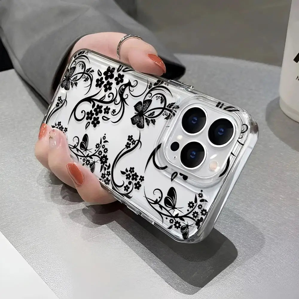 A clear phone case with a black floral pattern featuring butterflies is held by a hand.
