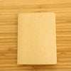 A blank A6 sketchbook lying on a wooden surface.
