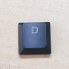 A close-up view of a single dark blue keycap with the letter D on it for a Dell Alienware keyboard.