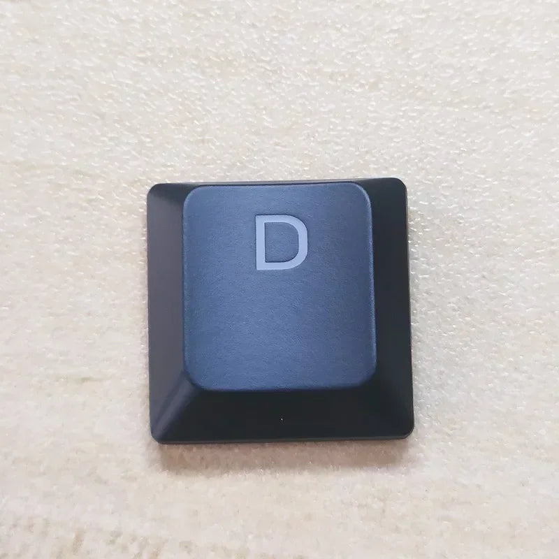 A close-up view of a single dark blue keycap with the letter D on it for a Dell Alienware keyboard.