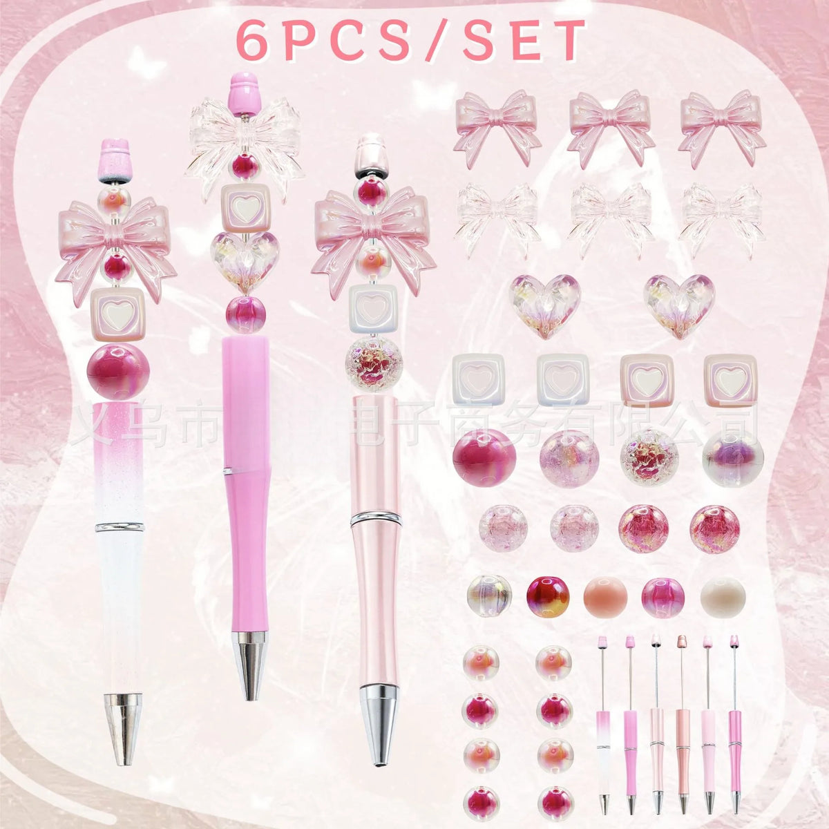 A set of six pink and clear acrylic beaded pens with decorative ribbons and gradient colors.