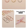 A collection of elegant metal pen clips in rose gold and gold tones shown in various styles for gripping papers.