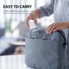 A person is easily carrying a small white USB-C fast charger and cable in a gray fabric pouch.