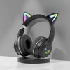 Black Bluetooth headphones with cat ear design and RGB lighting resting on a stand.