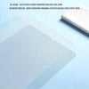 A clear tempered glass screen protector is shown on a light blue surface next to a white cloth.
