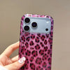 A hand holds a glamorous leopard print sequin shockproof phone case for an iPhone with a purple-pink background.