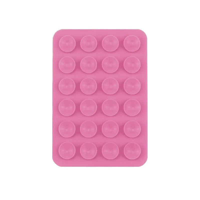 A pink silicone suction cup product featuring 24 small circular cups for mounting phones and tablets.