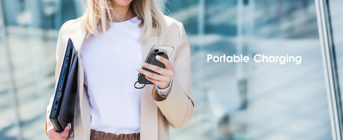 A woman holds a portable charger device while wearing a light jacket, demonstrating portable charging.