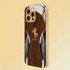 A beige phone case for an iPhone featuring a wood grain design and a golden horse silhouette.