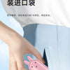 A hand is holding a pink portable foldable rabbit mini fan with a USB charging cable, demonstrating its use.