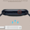 A black magnetic wireless charger is shown above a white connector, illustrating magnetic adsorption for precise alignment.