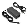 A black 65W USB-C laptop charger adapter with a cable and connector is shown on a white background.