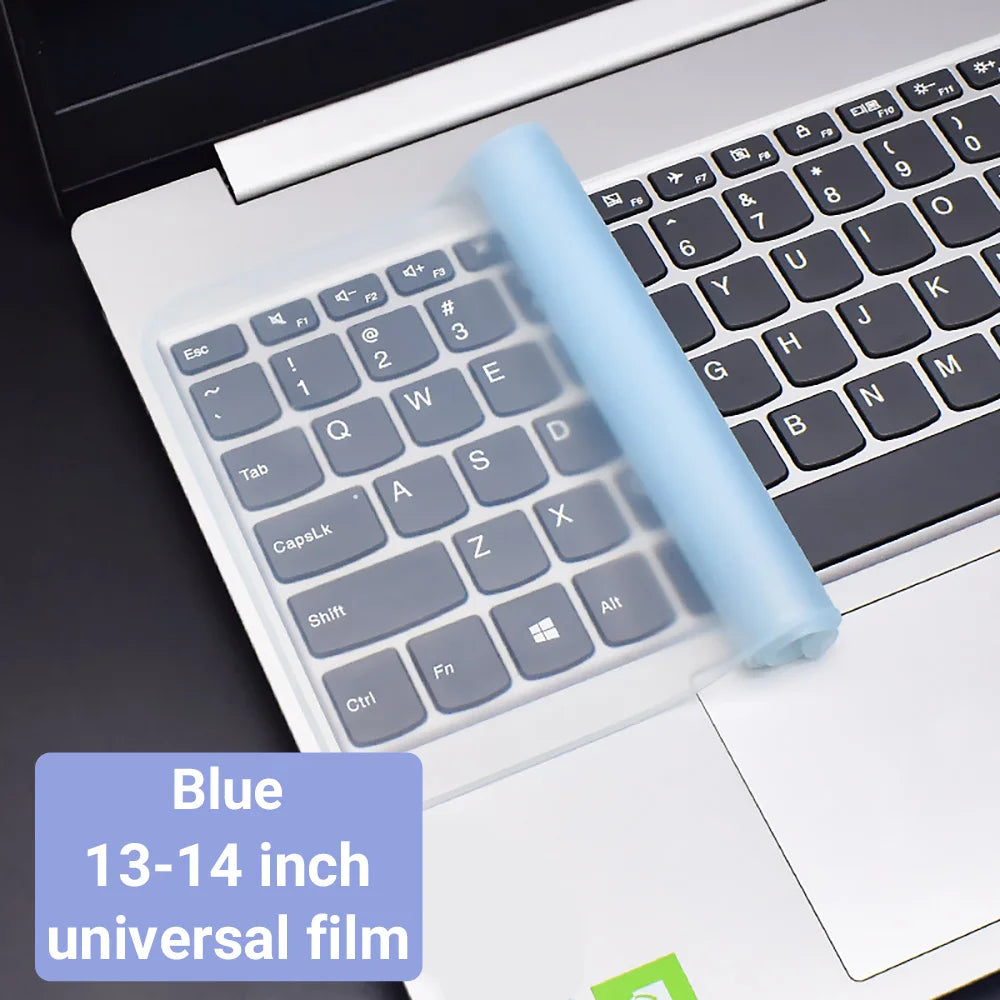 A blue silicone film keyboard cover is placed on a white laptop keyboard.