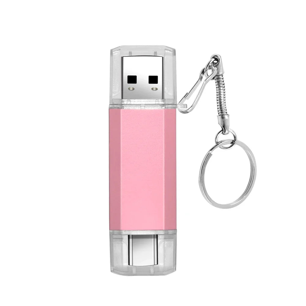 A pink dual USB and Type-C flash drive with a clear casing and a metal keyring attachment.