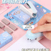 A white cartoon mini stapler is shown next to its packaging and a hand demonstrating its use.