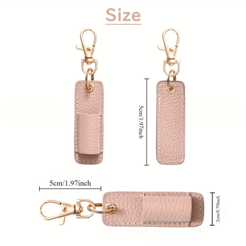 A light pink leather pen holder keychain with a gold-tone clasp and a rectangular tag.