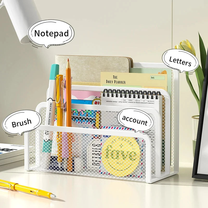A white metal mesh desk file organizer holding various stationery items like a notepad, letters, and pens.