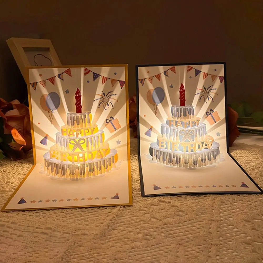 A set of musical LED birthday greeting cards featuring a tiered cake design and festive bunting.